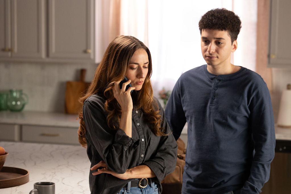 A brother and sister on the phone, talking about their mother