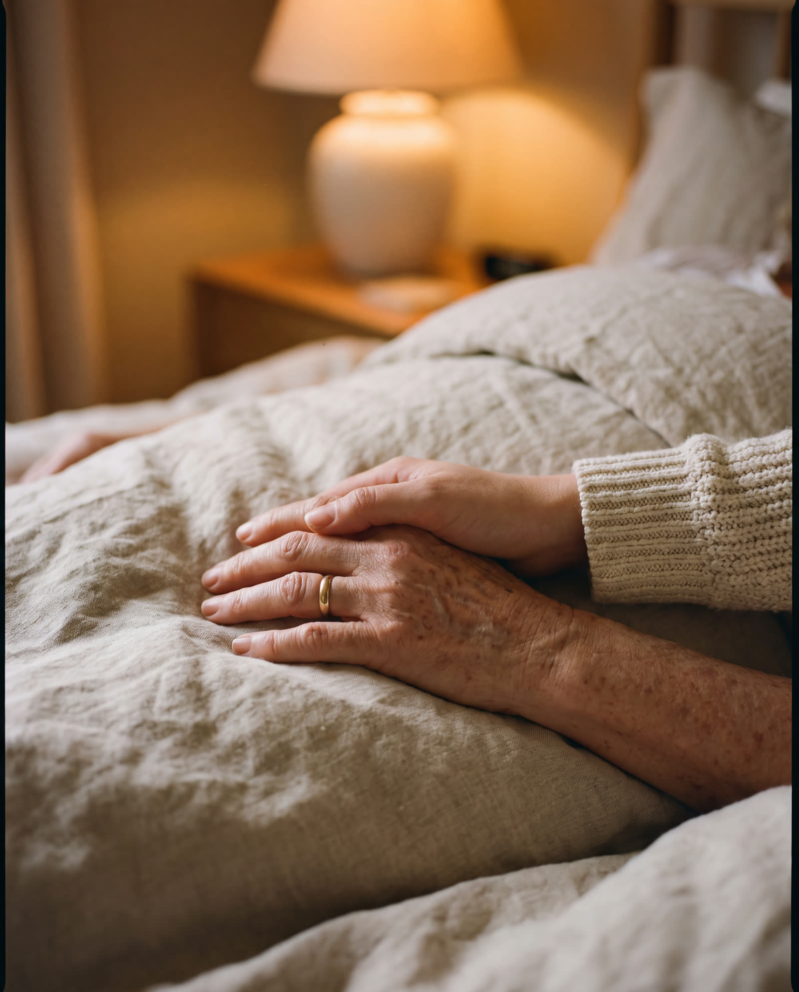 A daughter's hand resting on her mother's